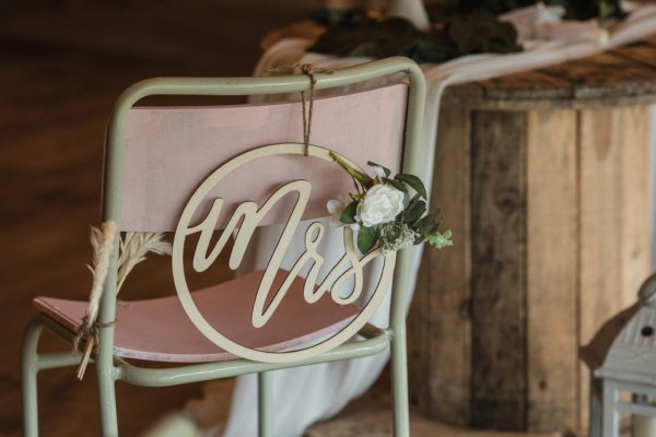 Mrs sign on back of chair white roses/flowers