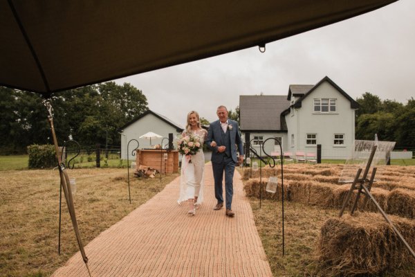 Bride and father walk down the aisle