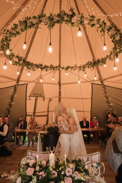 Family picture children marquee guests bride and bride lights above heads