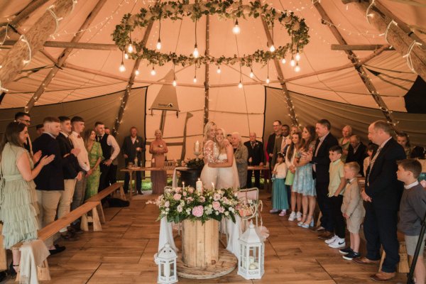 Family picture children marquee guests bride and bride