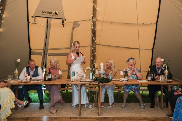 Bride giving speech at table