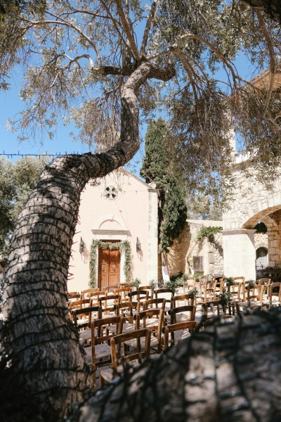 Exterior daytime wedding venue plants ceremonial seats seating area