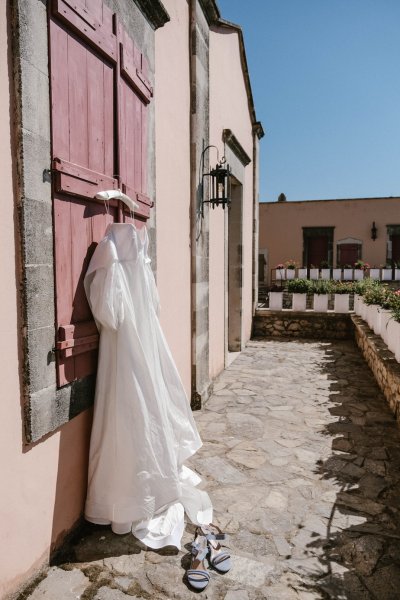 Wedding gown/dress hanging on door exterior balcony setting