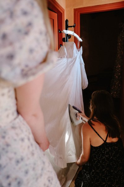 Close up of wedding gown steaming ironing