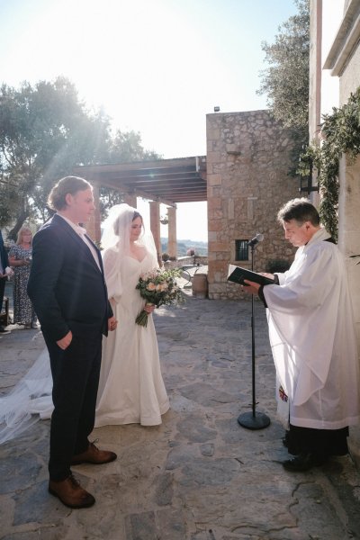 Groom and bride at alter with priest