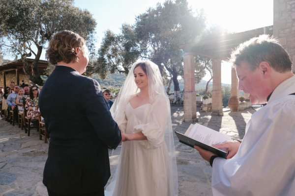 Bride and groom Greece priest officiant and guests