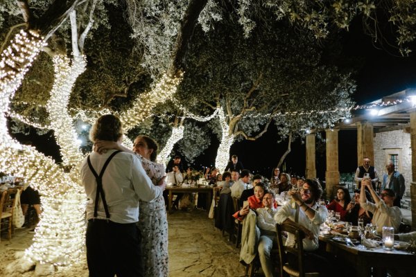 Bride and groom dance on the dancefloor lights in background