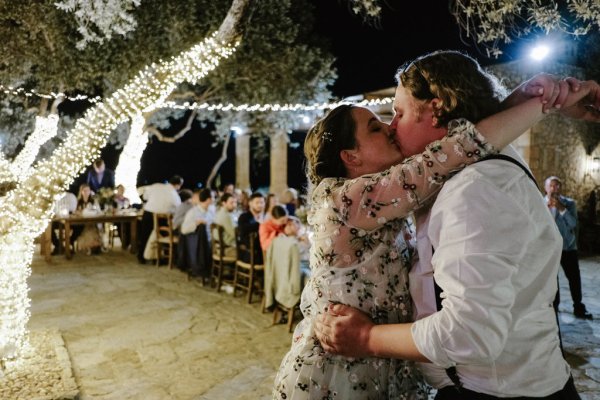 Bride and groom kiss on the dancefloor