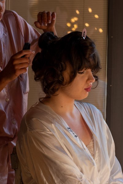 Bride getting her hair done by hairstylist