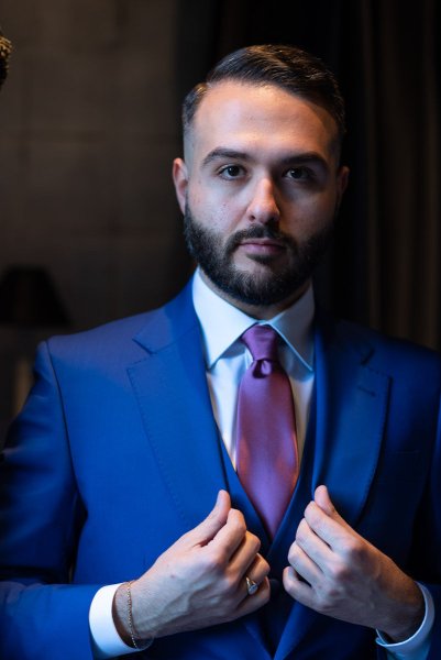 Groom holding suit ready for wedding