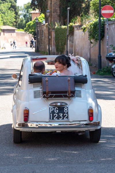 Bride looks over the shoulder in wedding car