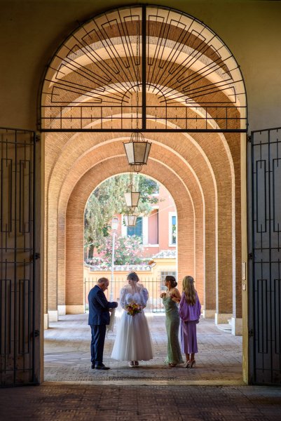 Bride and father and family members outside of church