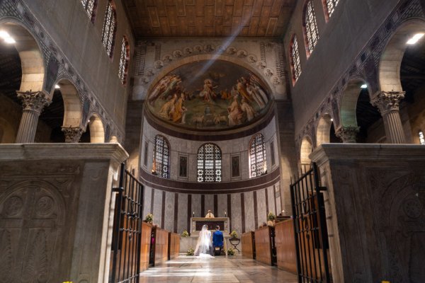 Interior cathedral setting bride and groom at alter