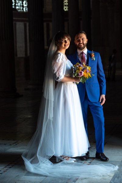 Dark photo of bride and groom shadow photography looking at camera