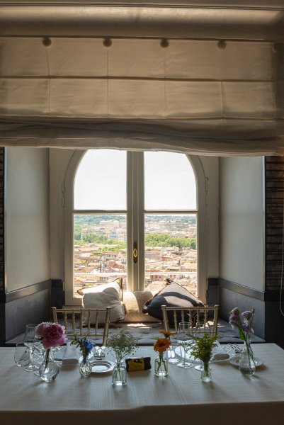 Interior view of exterior city landscape window shot and table setting for guests