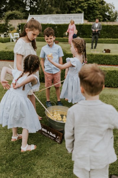 Little children girls and boys playing on grass