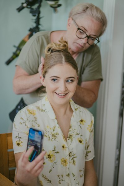 Bride getting her hair done hairstylist