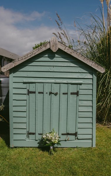 Exterior sunny garden shot with flowers/bouquet shed