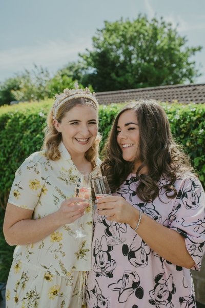 Bride cheers to the bridesmaids champagne prosecco