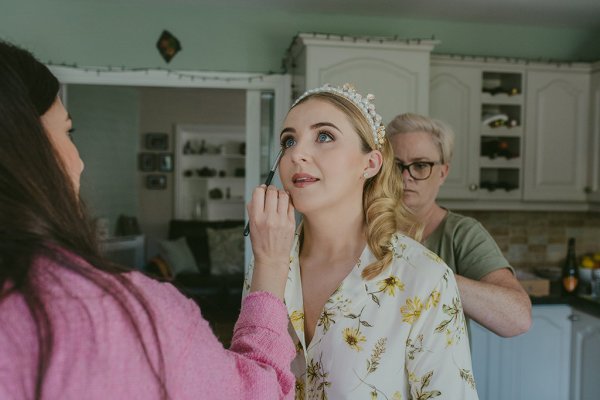 Bride is getting her makeup done MUA