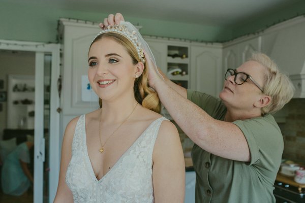 Bride exterior shot bouquet flowers garden close up makeup and hair detail