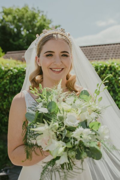 Bride exterior shot bouquet flowers garden close up