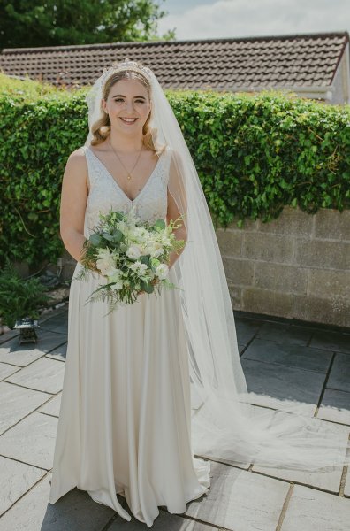 Bride exterior shot bouquet flowers garden