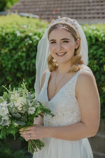 Bride exterior shot bouquet flowers garden close up