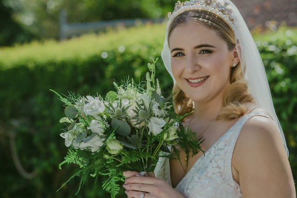 Bride exterior shot bouquet flowers garden close up