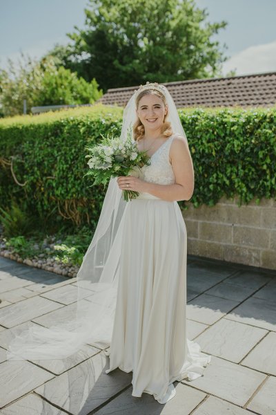 Bride exterior shot bouquet flowers garden