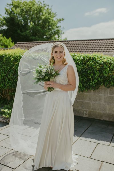 Bride exterior shot bouquet flowers garden