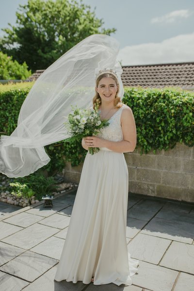 Bride exterior shot bouquet flowers garden