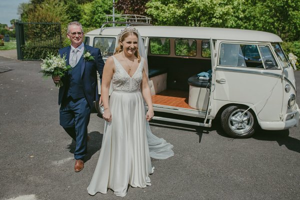 Father of the bride in sunshine exit wedding car