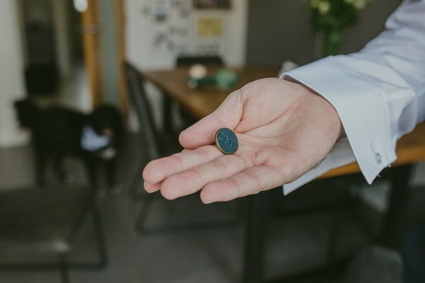 Cufflink groom accessory in hand