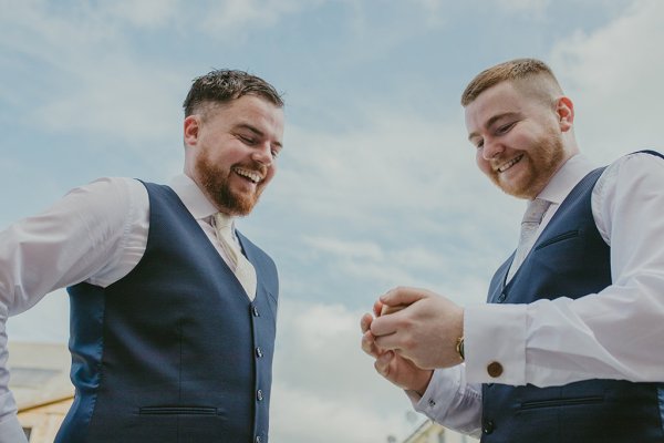 Groom and groomsman outside