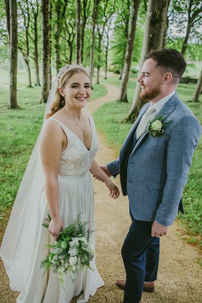 Couple bride and groom in park/forest bouquet of flowers