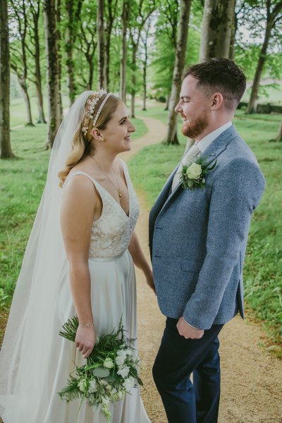 Couple bride and groom in park/forest bouquet of flowers