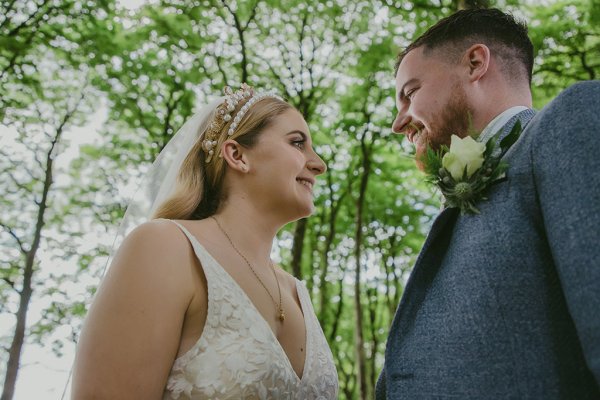 Couple bride and groom in park/forest bouquet of flowers