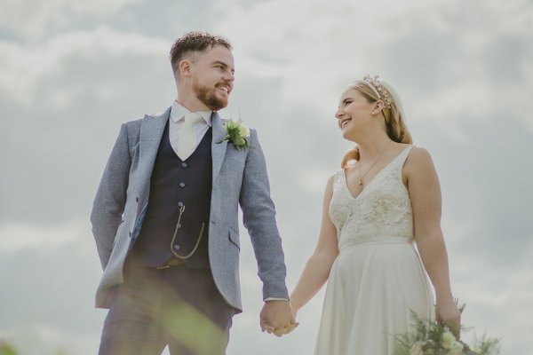 Couple bride and groom hand in hand holding hands