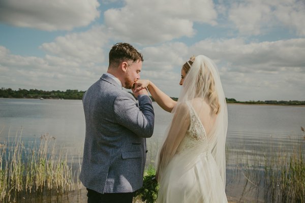 Groom kisses brides hand