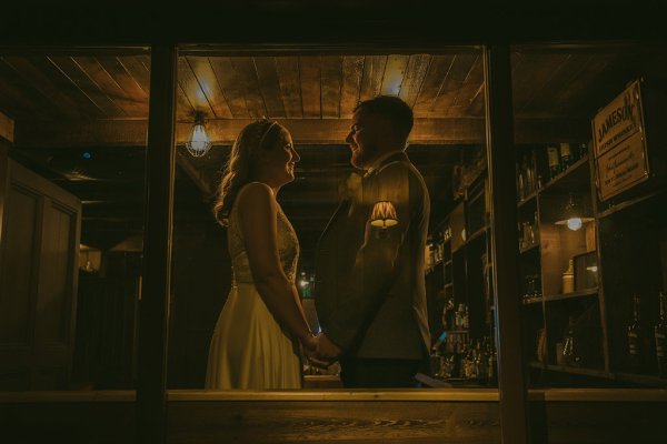 Tom's Fish & Tackle shop bride and groom stand outside