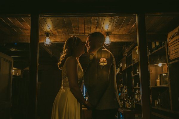 Tom's Fish & Tackle shop bride and groom stand outside