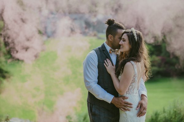 Bride and groom embrace hug in garden setting