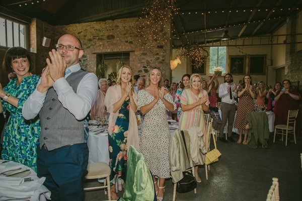 Guests clapping for couple