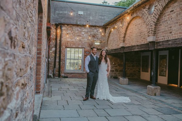 Lights in background couple bride and groom courtyard