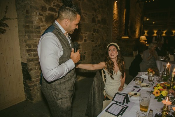 Groom giving speech to bride during ceremony