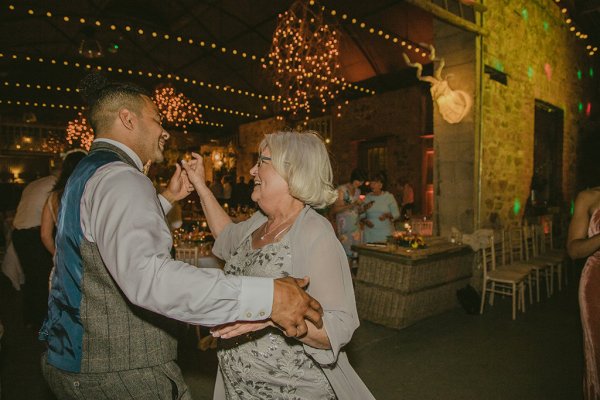 Groom and brides mother dance on dancefloor