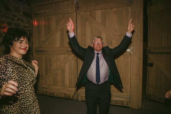 Man dances on dancefloor smiling