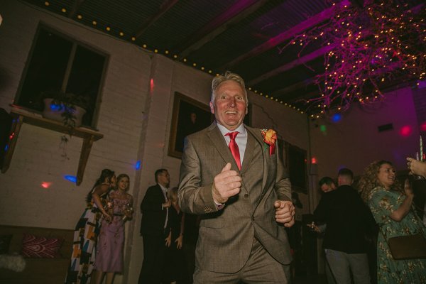 Man dances on dancefloor smiling