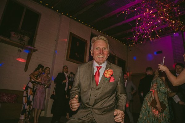 Man dances on dancefloor smiling